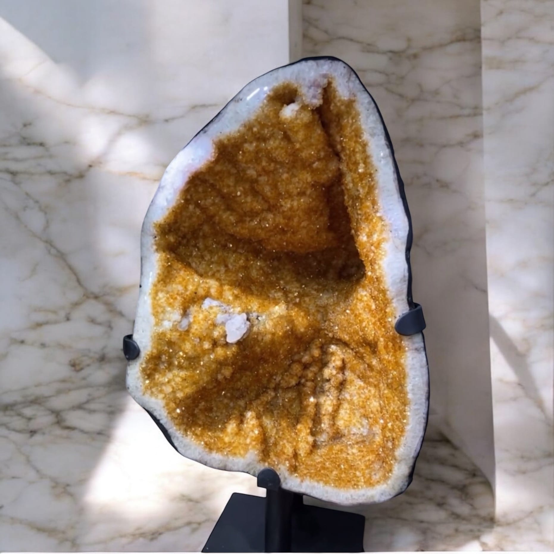 Polished amethyst point standing upright on table