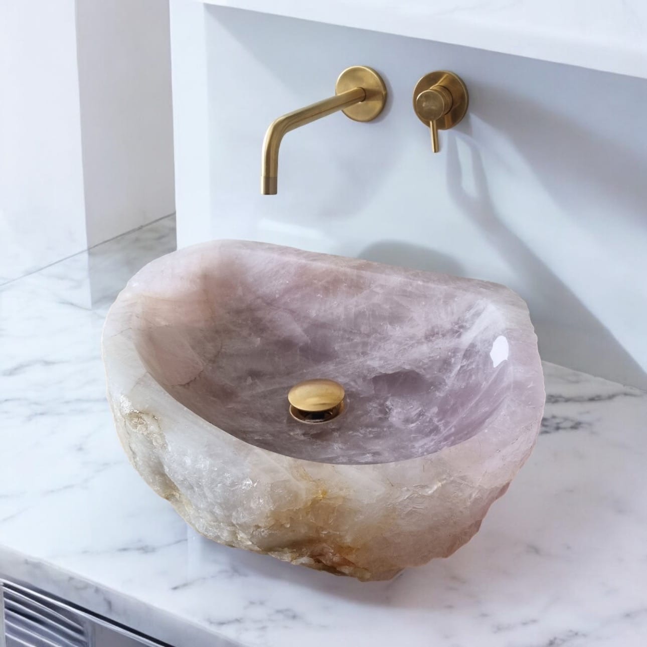 Purple quartz stone sink with gold faucet on marble countertop