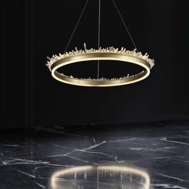 Modern circular chandelier with crystal accents hanging over black marble floor reflecting light