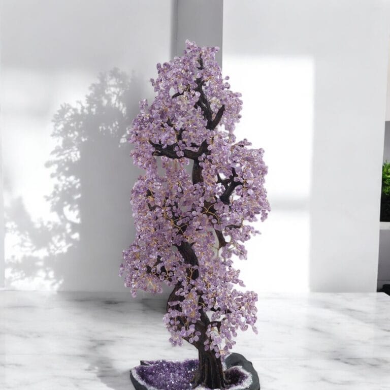 Handcrafted amethyst gemstone tree on marble table